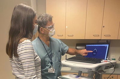 Dr. Rassekh pointing to imaging on screen